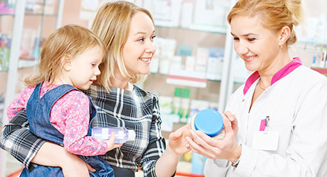Pharmacist helping a lady and baby